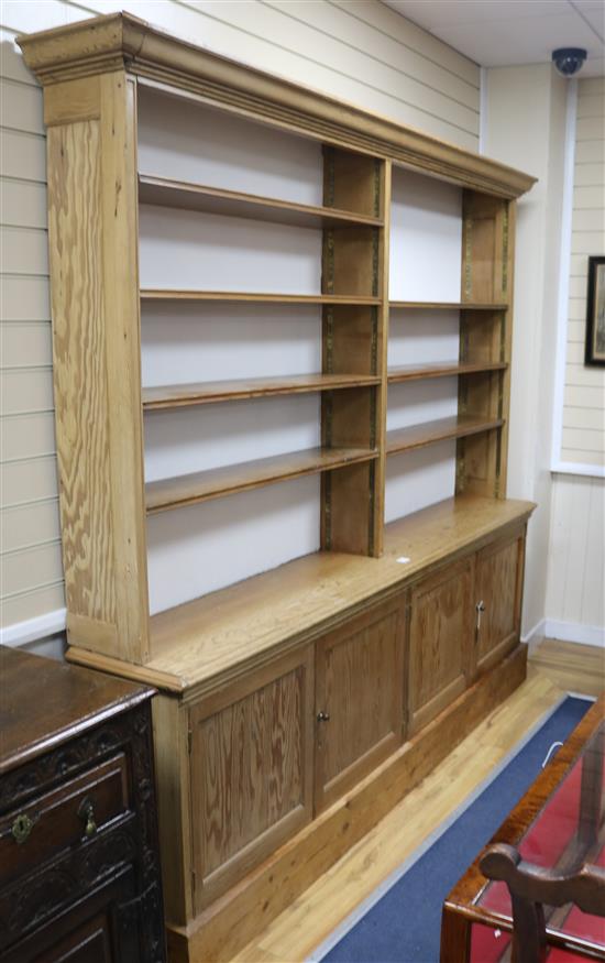 A pine open bookcase, W.229cm H.214cm